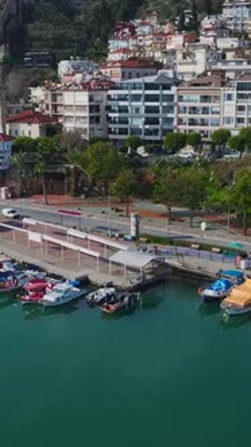 Vertical Video of a Luxury Yacht Marina Captured From Above With Elegant Boats and a Calm Blue Sea