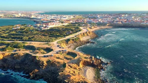 Fly Away Revealing Drone Shot Peniche Town Cliffs and Sunset Portugal