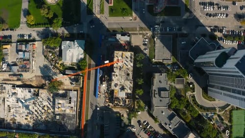 Vertical Top View of Construction Crane in City Stock Footage Building Under Construction in Center