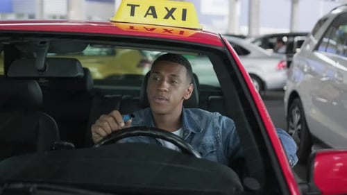 Young Adult Man Driving a Taxi Cab