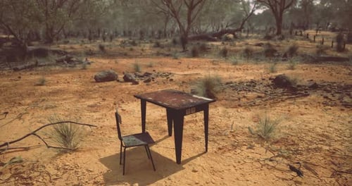 Lonely School Table and Chair Abandoned in the Arid Wilderness During Midday