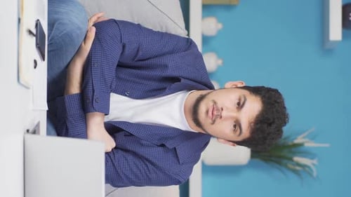 Vertical video of Man looking thoughtfully at camera.