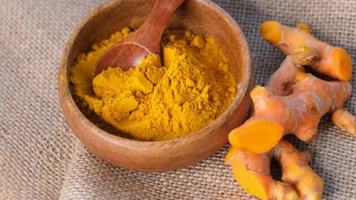 Turmeric Powder and Roots Curcuma Longa Kurkuma Panning Turmeric on Black Background Top View Close