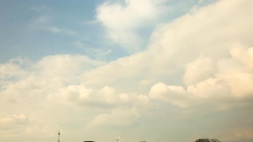 Time lapse of thick and fluffy clouds forming against a blue sky with turmoil of growing and diminis
