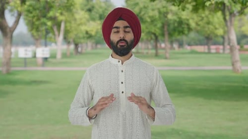 Sikh Indian man doing Yoga in park
