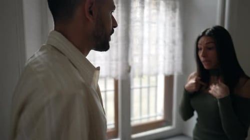 Man and Woman Arguing Intensely in an Apartment
