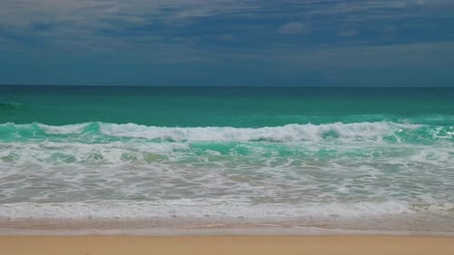 Tranquil Beach Scene Depicting Gentle Waves Crashing Onto Sandy Shore