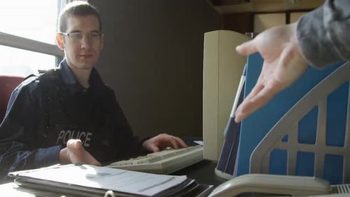 Police Officer Receives Documents in Office