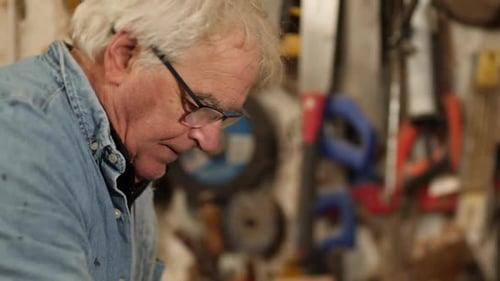 Senior Man Working with Wood in Workshop