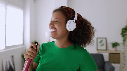 Enthusiastic Woman Cleaning and Singing at Home