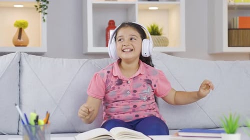 Happy Girl Listening to Music and Dancing