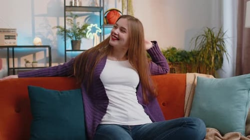 Smiling Woman Relaxing on Couch at Home