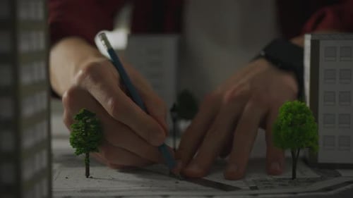 A Caucasian European man takes steps towards designing in a design studio, carefully studying