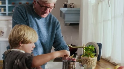 Grandfather and Grandson Baking Together in Kitchen