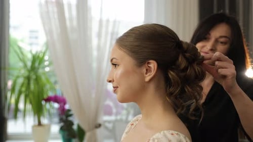 Professional Hairstylist Creating Wedding Hairstyle for Bride