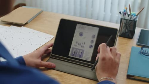 Working on Tablet with Business Graphics and Charts