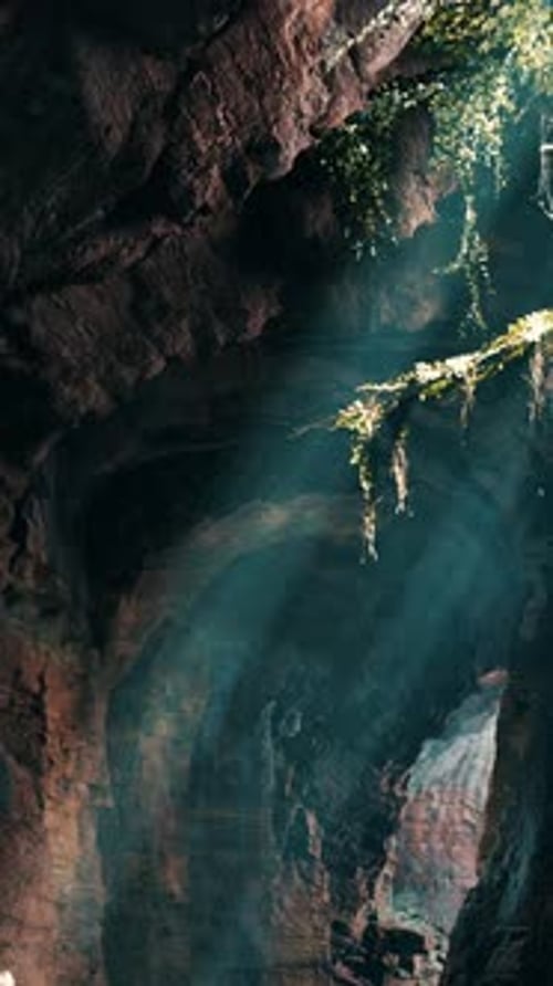 A Mesmerizing Green Light Shining Through the Entrance of a Mystical Cave