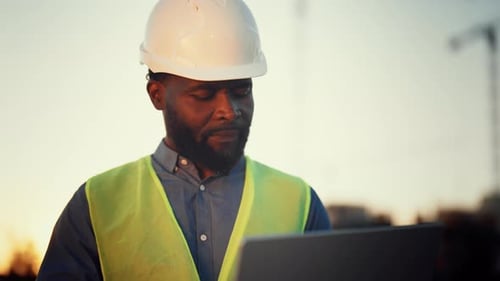 Inspired African American Man Looking at Construction Site and Dreaming Portrait of Professional