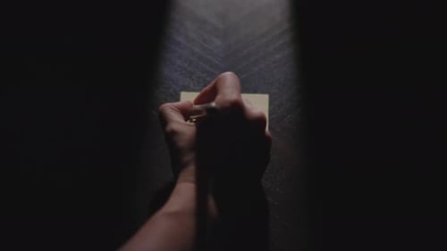 TUESDAY written on a piece of paper and placed under dramatic light