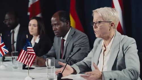 Business People Speaking at Corporate Meeting