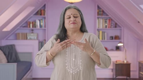 Woman Performing Hand Exercises in Bedroom