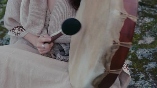 Woman Playing Shaman Drum in Natural Setting
