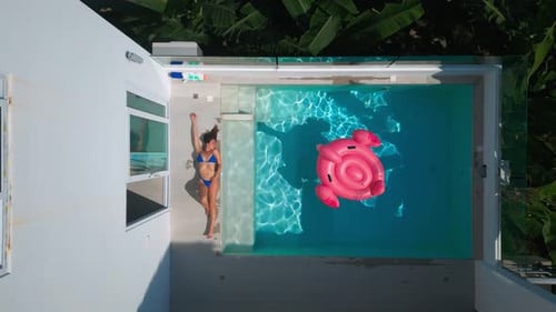 Top View Young Female in Bikini Chilling and Relaxing Near Private Swimming Pool at Hot Summer Day
