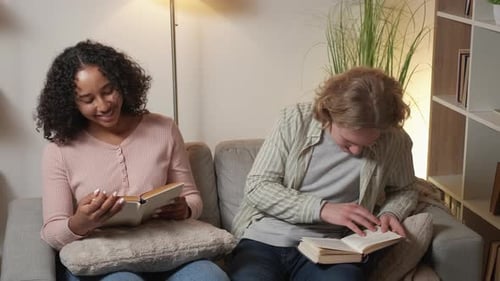 Friends Reading Books Together on a Cozy Couch