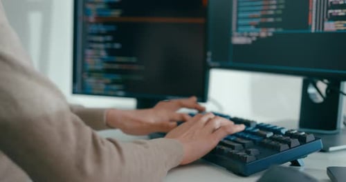 Young Adult Coding on Keyboard in Workplace