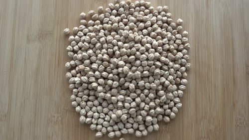 Pile of Dried Chickpeas on Wooden Board