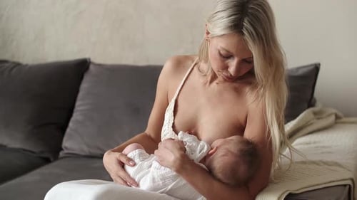 Mother Breastfeeding Baby in Home Setting