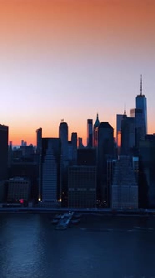 Shadow of New York on orange sunset. Manhattan silhouette city. Vertical video
