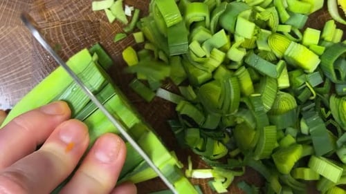 Fresh Leeks Sliced Neatly on Wooden Cutting Board