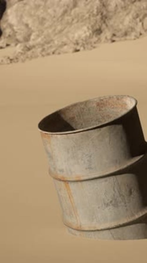 A Barrel Sitting in the Middle of a Desert