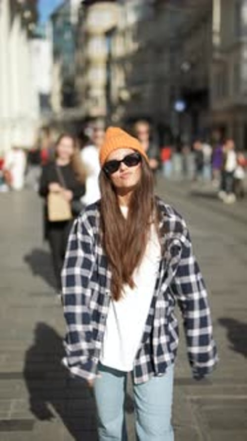 Stylish Woman Walks on Sunny Urban Street