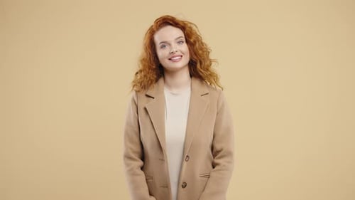 Smiling Woman with Red Curly Hair in Studio