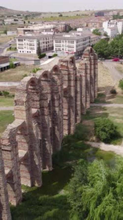 Circling Drone View of Historic Aqueduct and Cityscape. Vertical