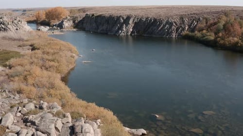 Aerial View of River Flowing Through Rocky Landscape
