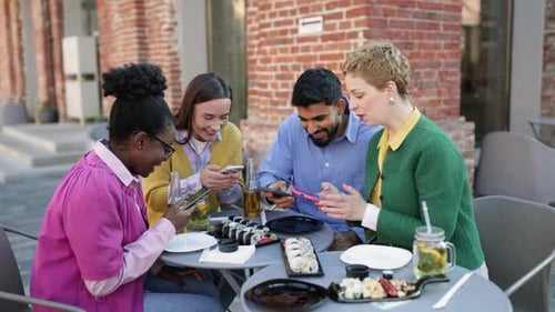 Friends Enjoying Meal at Outdoor Cafe