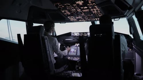 Pilots in a Plane Cockpit Working