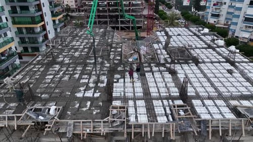 Builders Pour Concrete on the Floor of a New Residential Complex During Construction