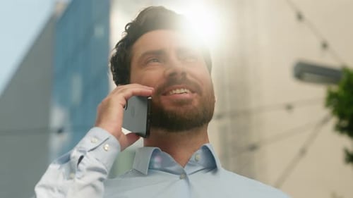 Close Up Caucasian Business Man Smiling Talking Mobile Phone Outside Sunny City Discussing Deal
