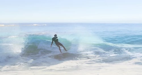 Animation of landscape with ocean over caucasian male surfer surfing