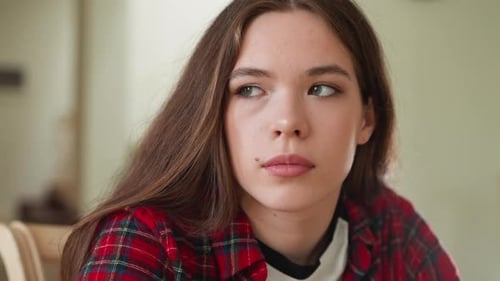 Pensive Young Woman Looking Away Indoors