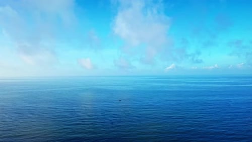 Aerial Top view of a transparent blue sea with beautiful waves at sunny day in summer. air of ocean