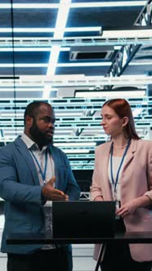 Vertical Video Data Center Coworkers Collaborating to Manage Cloud Computing IT Solutions