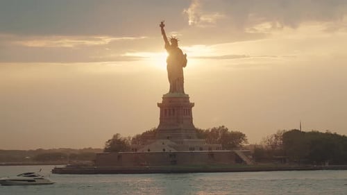 Waterfront shot of Statue of Liberty from the boat at sunset