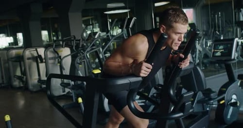 Athletic Man Has Cardio Workout at Gym and Walking on Treadmill