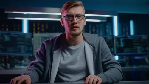 Man Working at Computer in Dark Room