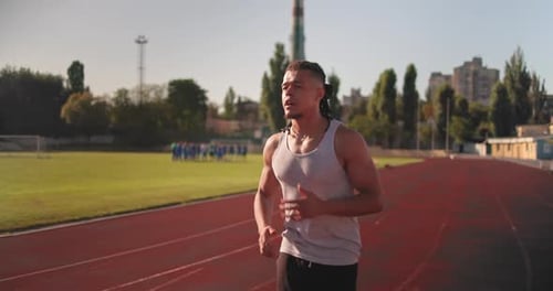 Young African American Runner Athlete Jogging at the Stadium